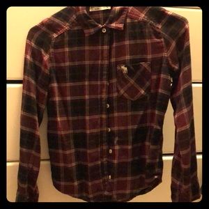 A maroon, black, and white button up shirt.